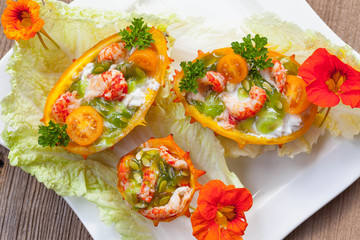 Exotic Shrimp salad served in n half a kiwano and leaves of the Chinese cabbage for summer party on...