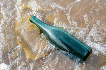 Green Bottle in a Murky Lake