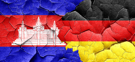 Cambodia flag with Germany flag on a grunge cracked wall