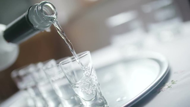 Close-up of Vodka Poured into a Shot Glass.