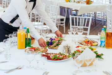 Waiter serving banquet table at a restaurant