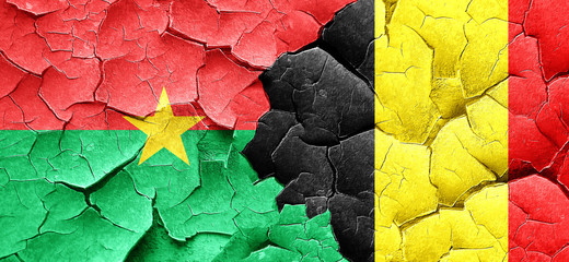 Burkina Faso flag with Belgium flag on a grunge cracked wall