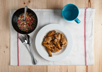 plate of chicken wings spicy on wooden table