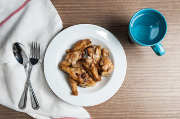 plate of chicken wings spicy on wooden table