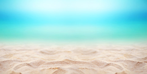 Close up sand with blurred sea sky background, summer day, copy space or for product. Panorama.