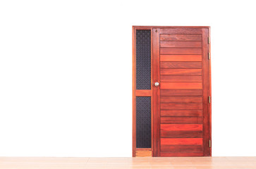 The brown wooden door on the white wall