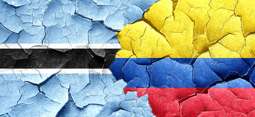 Botswana flag with Colombia flag on a grunge cracked wall