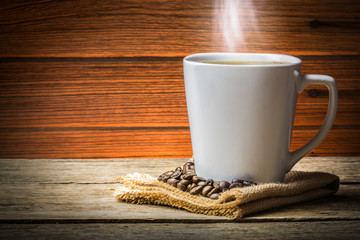 Coffee Cup and Beans on Wooden Table