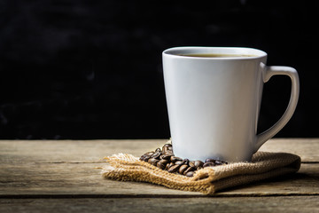 Coffee Cup and Beans on Wooden Table