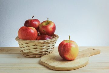 Fresh red apple still life concept. There are apple on the support and in the wood bowl. Vintage tone