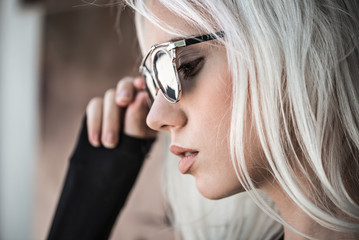 Beautiful young blonde girl in sunglassses outdoor