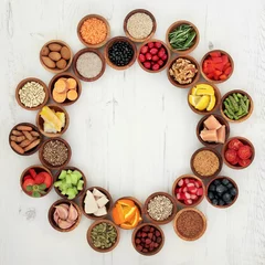 Foto op Plexiglas Healthy Super Food Selection.  Food selection in wooden bowls forming a wheel over distressed white wood background. High in antioxidants, vitamins, minerals and anthocyanins. © marilyn barbone