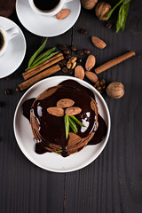 .chocolate pancakes with chocolate sauce. coffee. breakfast