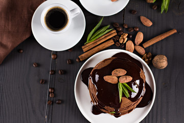 .chocolate pancakes with chocolate sauce. coffee. breakfast