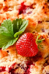 Fresh single strawberry on fruit pie with berries
