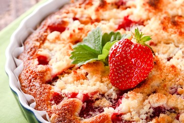 Fresh strawberry on fruit cake on green towel