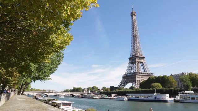 Eiffel tower and Seine river in a sunny day in Paris, windy
