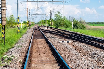 Fototapeta na wymiar Railway tracks with railroad switch in a rural scene