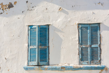 Two old traditional blue greek wooden windows in Rhodes, Greece
