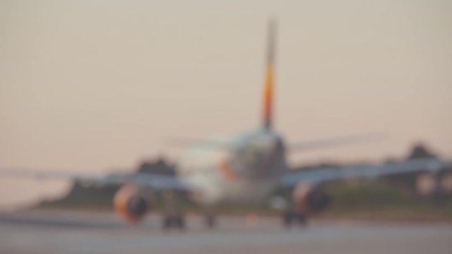 De-focused airplane rolling on a runway.