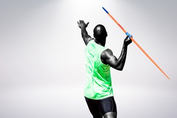Rear view of man throwing javeline against white background against grey background