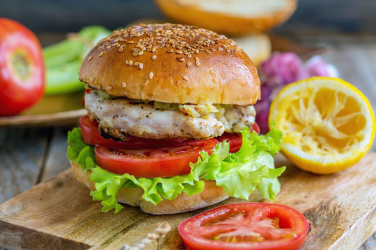 Burger with vegetables, chicken and spicy sauce.
