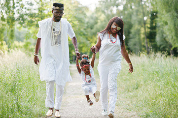 Naklejka na ściany i meble African american family at white nigerian national dress having