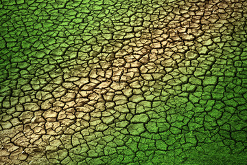 Dry cracked land with green grass texture. Two different concept with green and brown color. Dry...