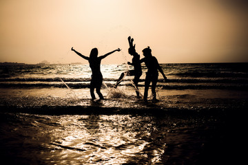 Girls at the beach, having fun in the water.
