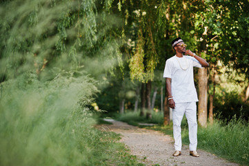 Portrait of stylish and rich black african american man on white