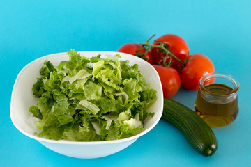 Fresh tomato, lettuce and cucumber for salad with olive oil