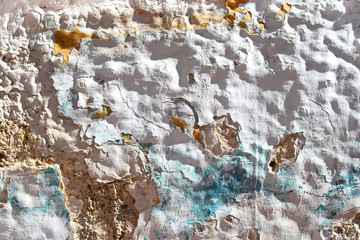 old  white wall with texture and blue and orange colors
