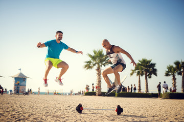 Two handsome athletes working out at the beach.