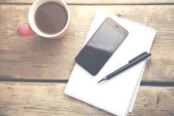 coffee,pen,phone and notebook