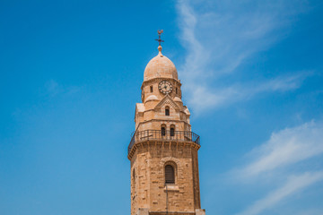 Fototapeta na wymiar The clock tower of the Abbey of the Dormition building at mount zion in Jerusalem