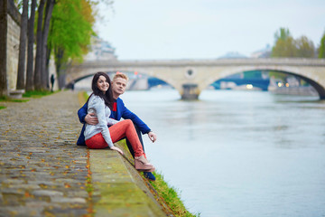 Romantic couple in Paris near the Seine