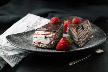 Chocolate cake with strawberries and cup of coffee