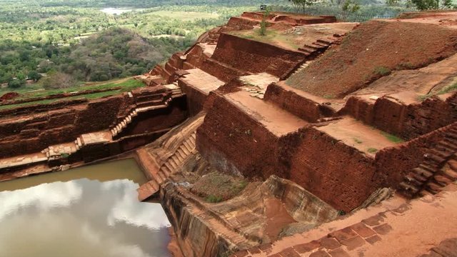 View to the ruins of the palace and pond at the ancient Sigiriya rock fortress in Sigiriya, Sri Lanka.