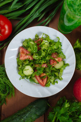 plate with vegetarian salad from vegetables among vegetables