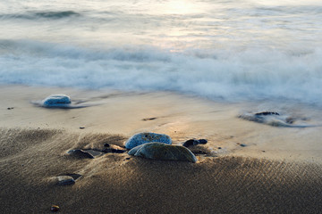 Fototapeta na wymiar Ocean washing over rocks at the beach, Mancora, Peru 
