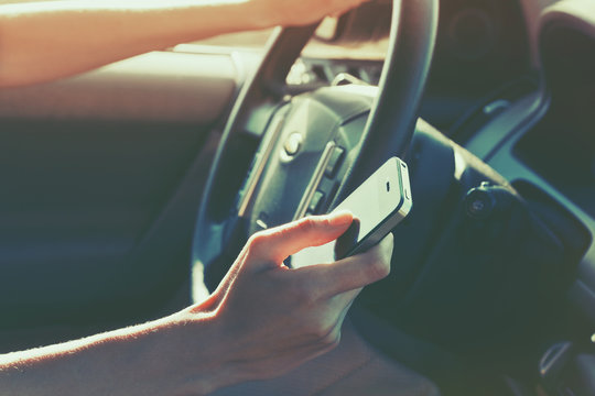 Girls Hand Using Smart Phone While Car Driving