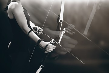 Composite image of sportswoman practicing archery - obrazy, fototapety, plakaty