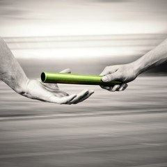  Man passing the baton to partner on track