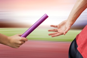 Image of athlete passing a baton to the partner