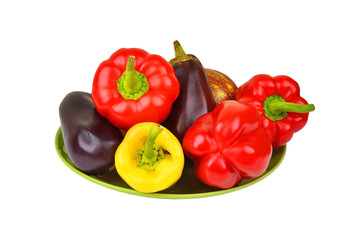 Eggplant and pepper on plate, isolated on white background