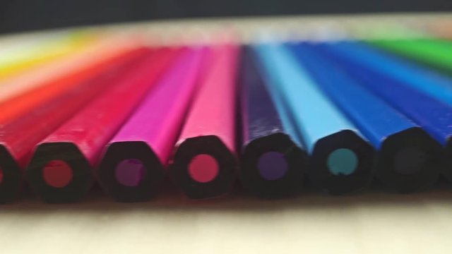 Row of unsharpened ends of color pencils close up dolly video