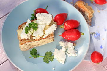 Fresh healthy breakfast, a slice of soda bread with butter and cottage cheese and red radish