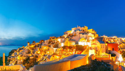Panoramic famous view, Old Town of Oia or Ia on the island Santorini, white houses and windmills at...