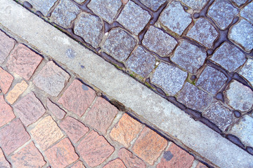 Cobblestone floor red and black divided by a strip of cement