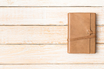 Leather diary notebook on white wooden background, Business temp